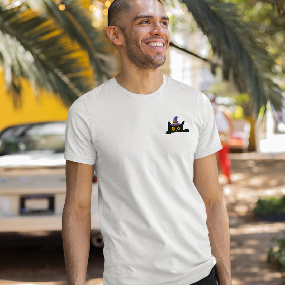 a man wearing a white t - shirt with a picture of a cat on it