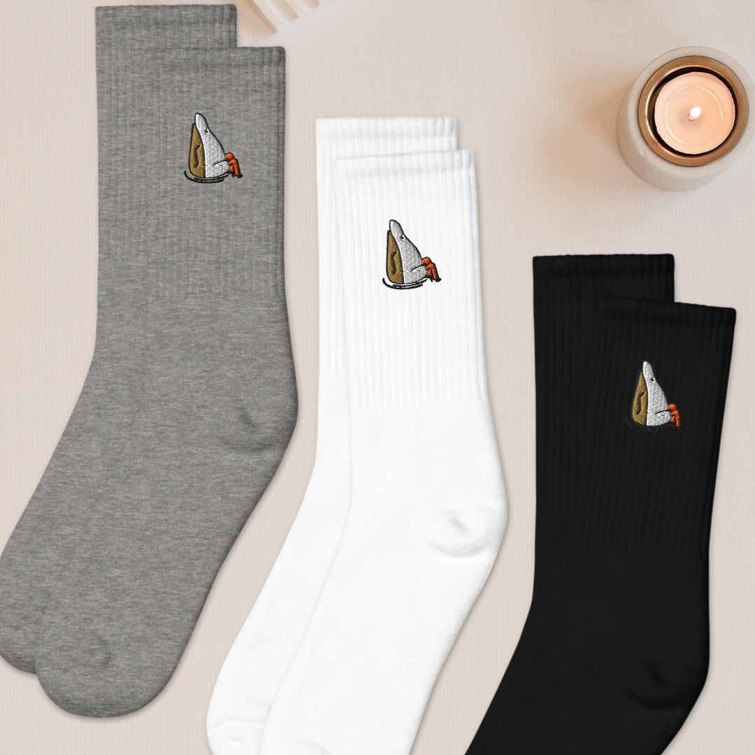 three pairs of socks sitting on top of a table