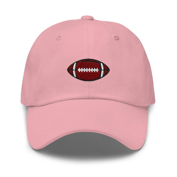 a pink hat with a football embroidered on it