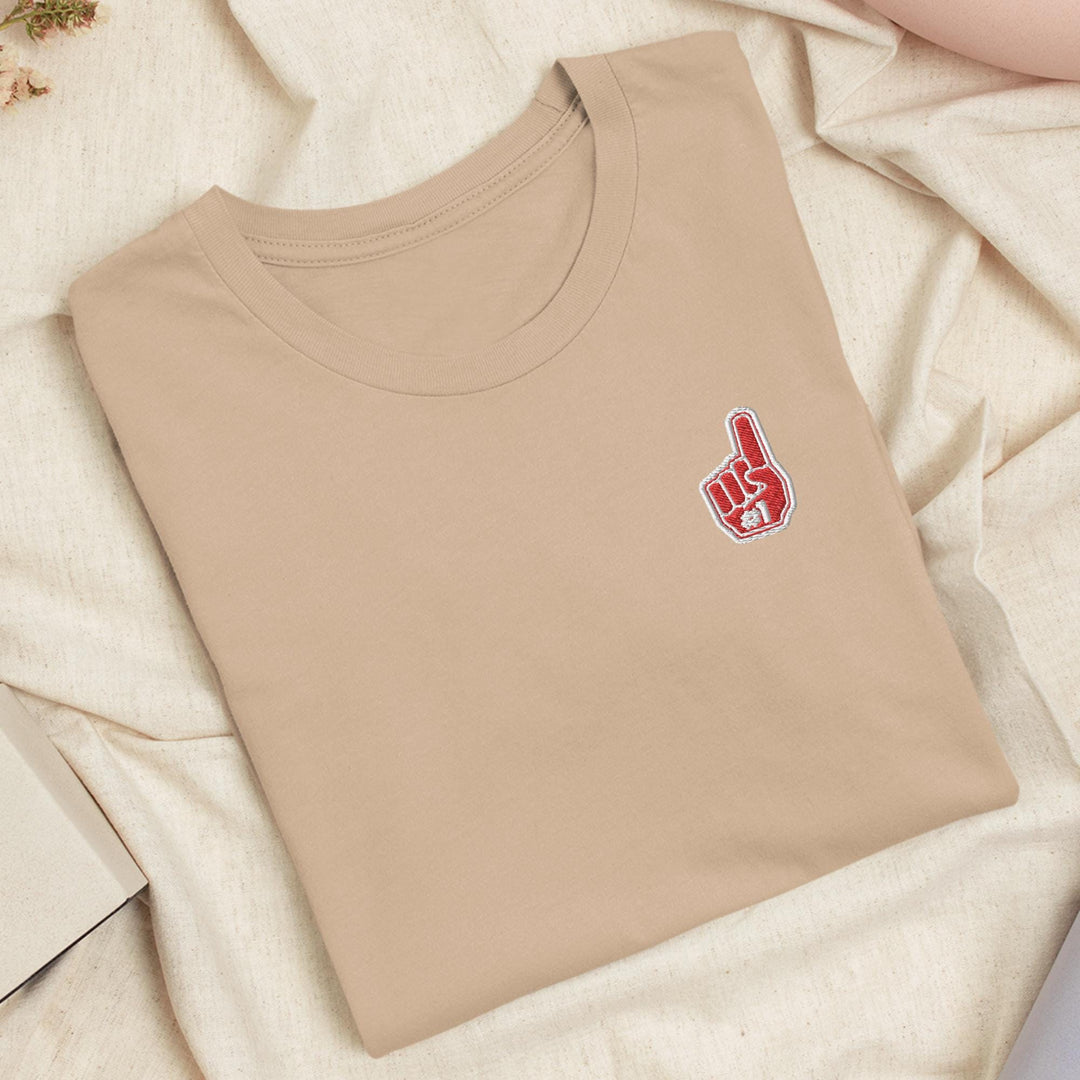 a t - shirt with a peace sign on it laying on a bed