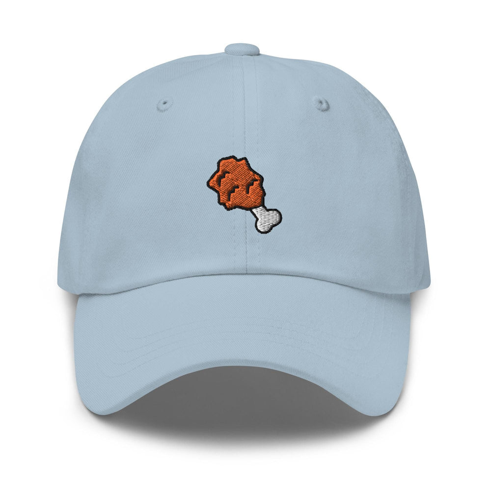 a light blue hat with an orange piece of food embroidered on it