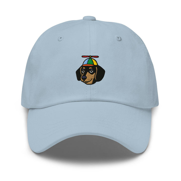 a light blue hat with a dachshund wearing a hat