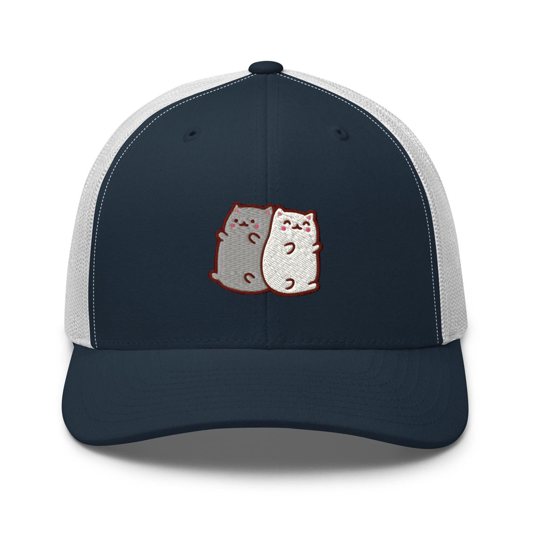 a blue and white trucker hat with two cats on it