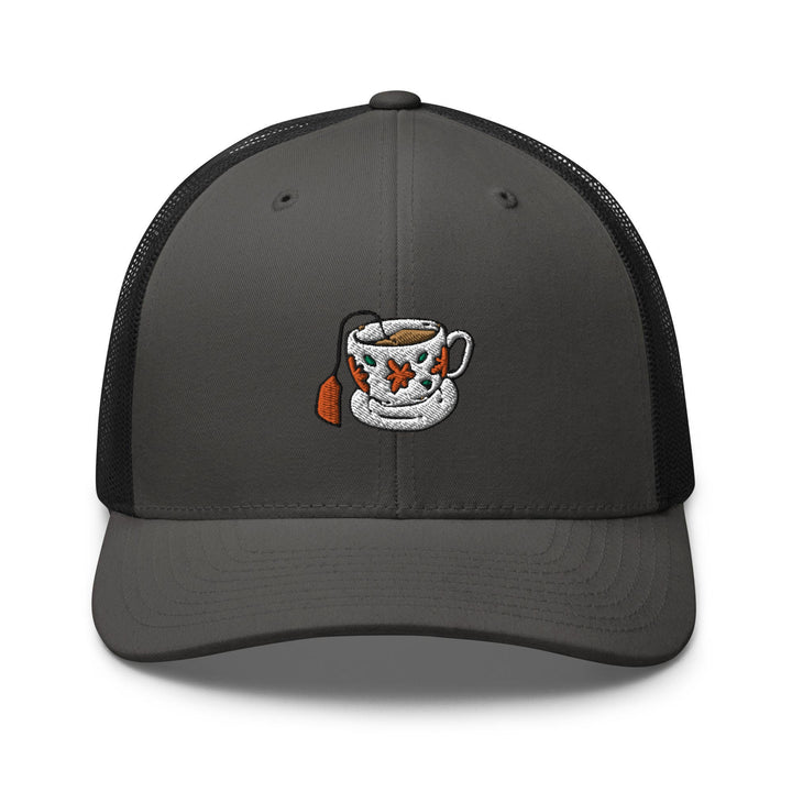 a gray trucker hat with a black mesh back and a picture of a coffee