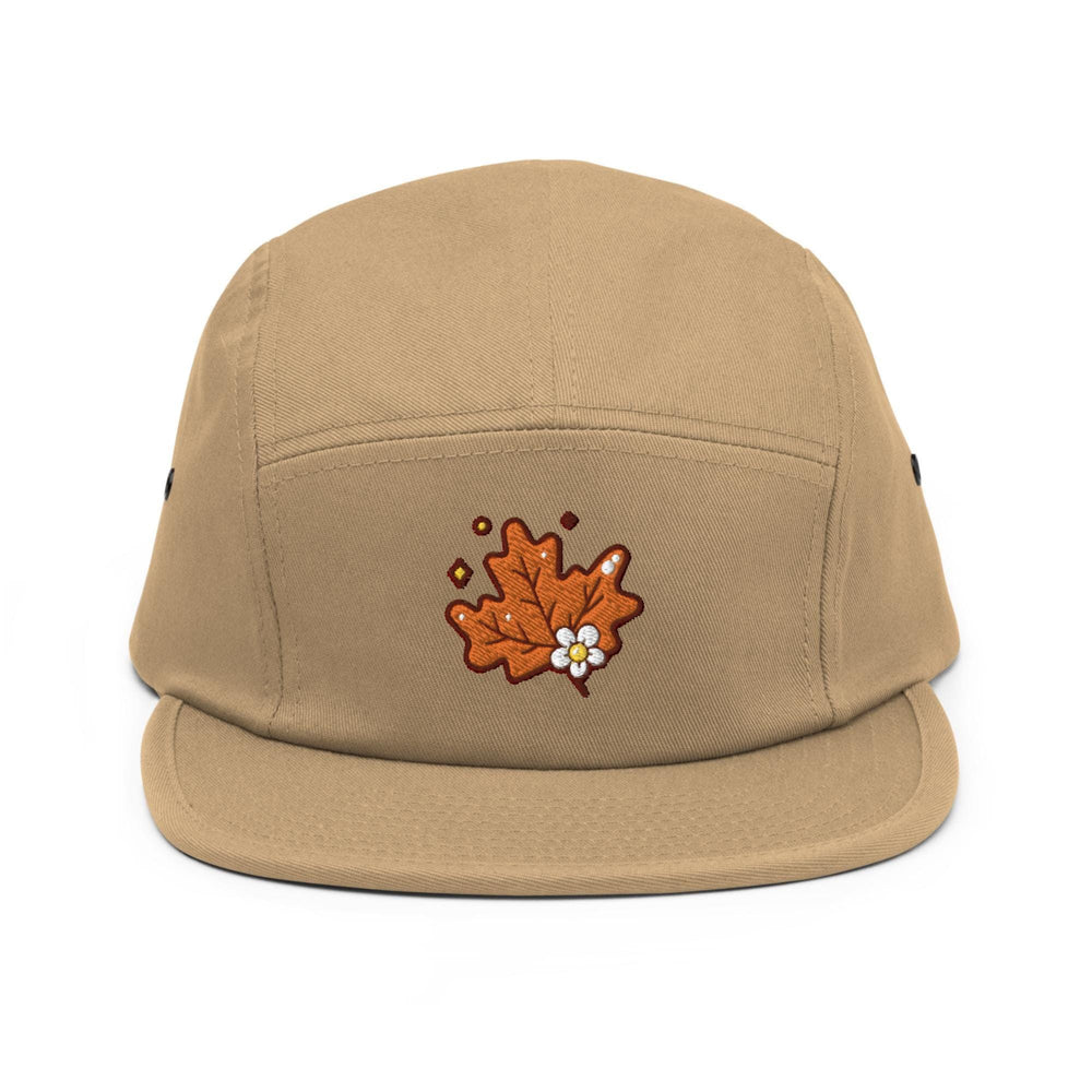 a tan hat with a flower embroidered on it