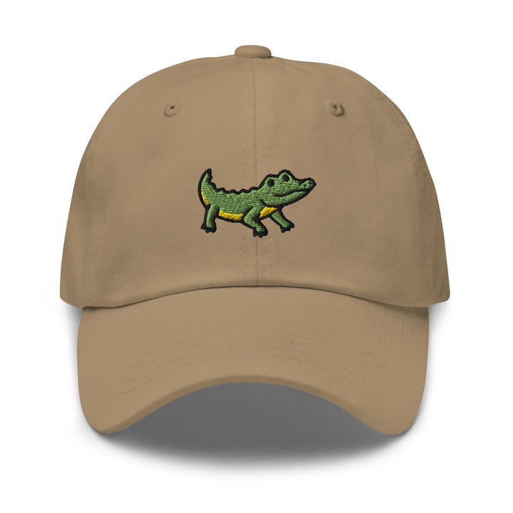 a tan hat with a green alligator embroidered on it