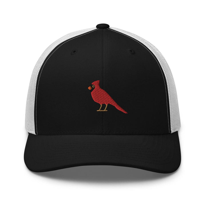 a black and white trucker hat with a red bird on it