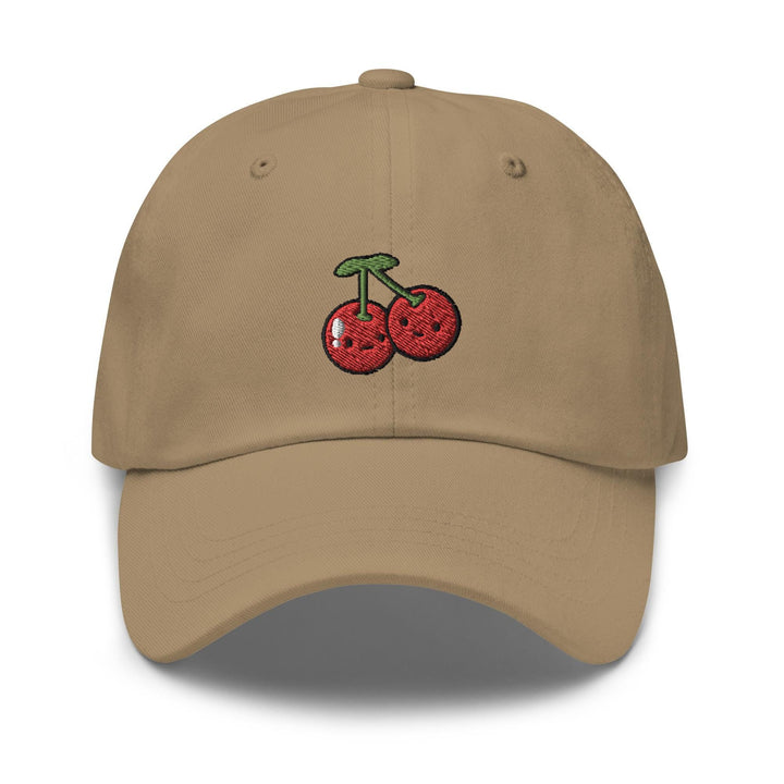 a tan hat with a cherry embroidered on it