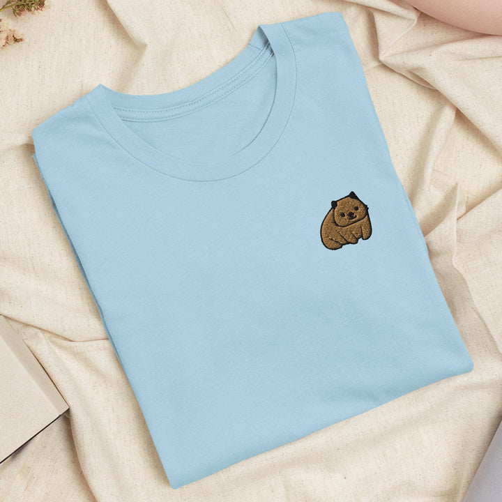 a blue shirt with a brown bear embroidered on it