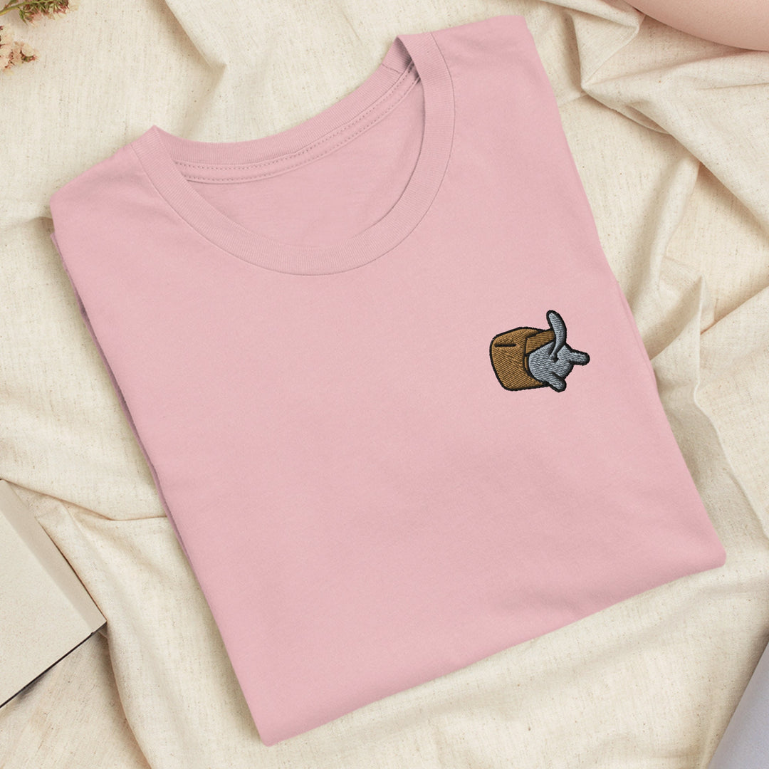a pink t - shirt with an elephant embroidered on it