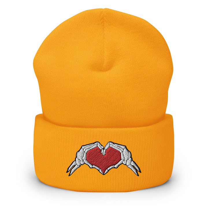 a yellow beanie with a heart and wings on it