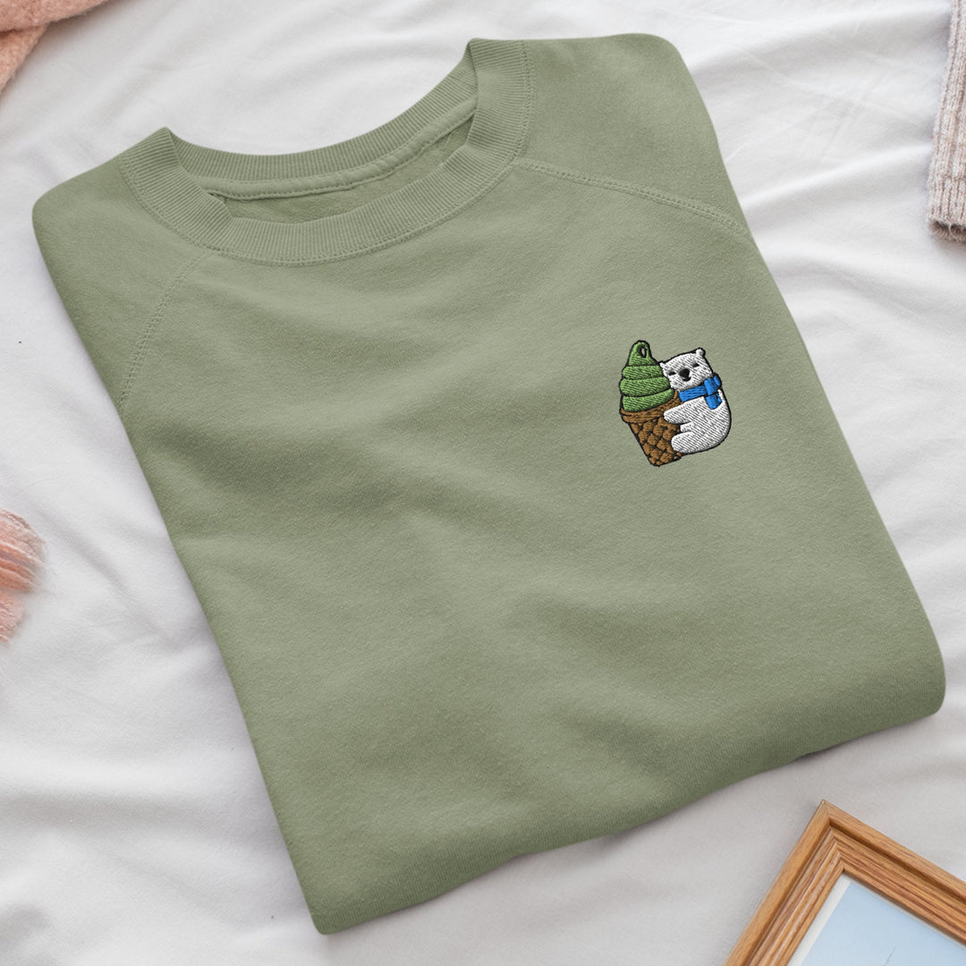 a green t - shirt with a cartoon bear on it