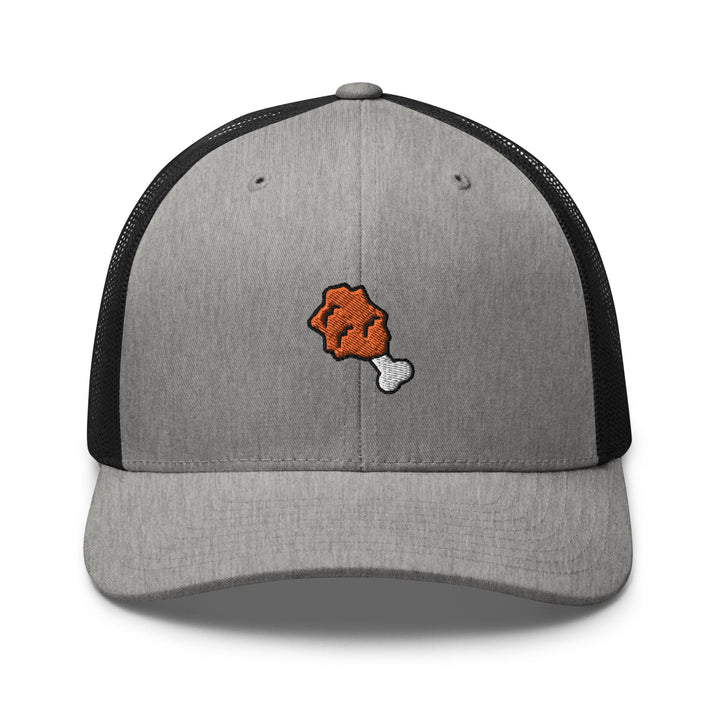 a gray and black trucker hat with an orange dog bone