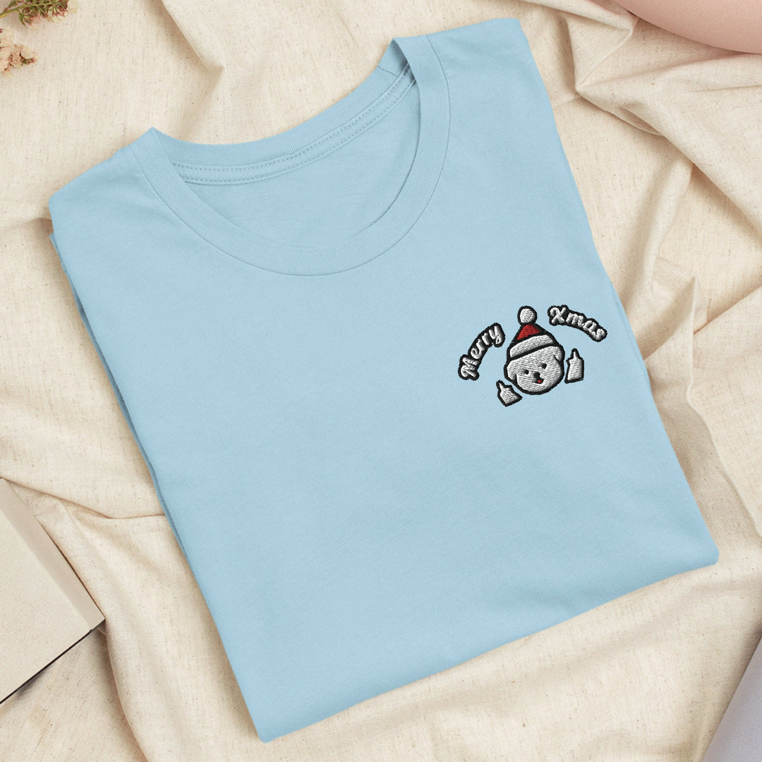 a blue t - shirt with a teddy bear embroidered on it