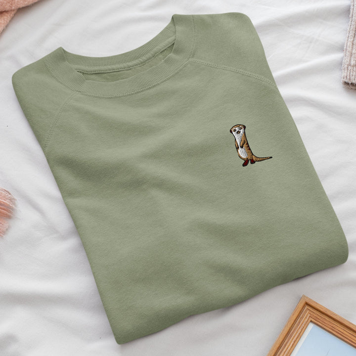 a t - shirt with a picture of an otter on it