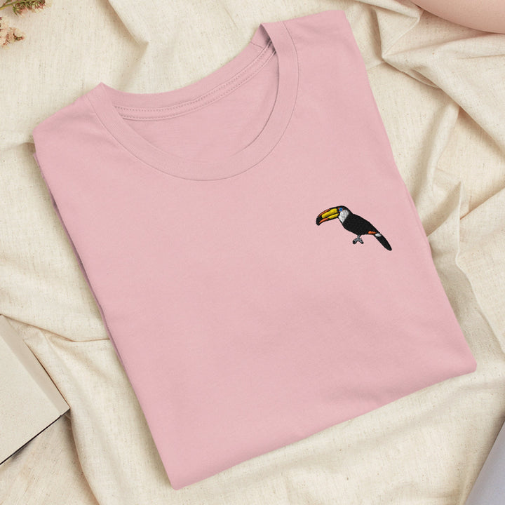 a pink t - shirt with a bird embroidered on it