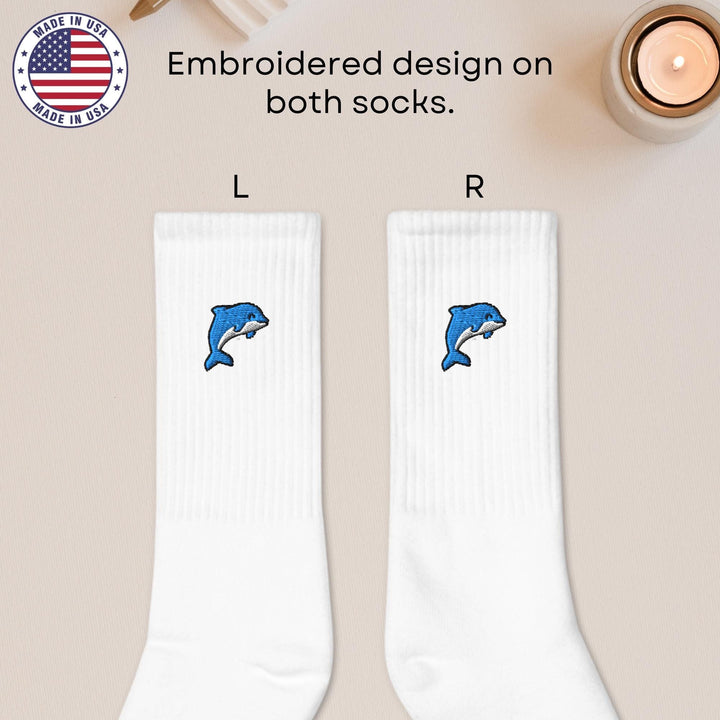 a pair of white socks with dolphins on them