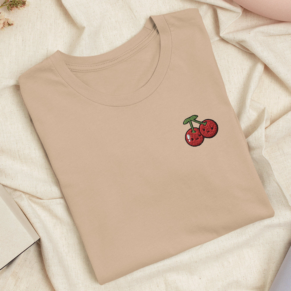 a t - shirt with a cherry embroidered on it