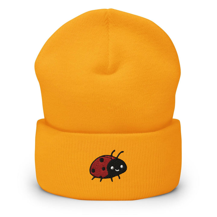 a yellow beanie with a ladybug on it