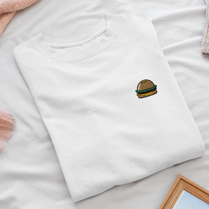 a white shirt with a hamburger embroidered on it