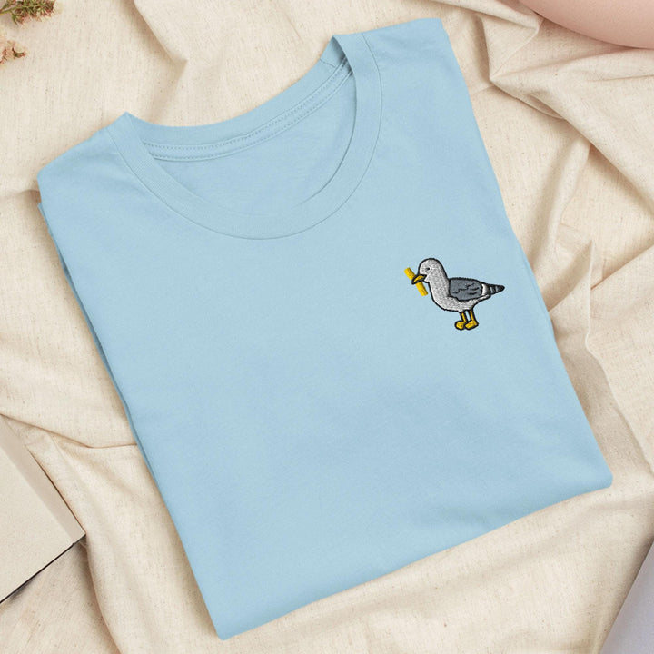 a blue t - shirt with a bird embroidered on it