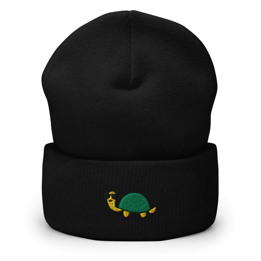 a black beanie with a green turtle on it