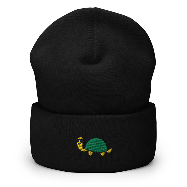 a black beanie with a green turtle on it