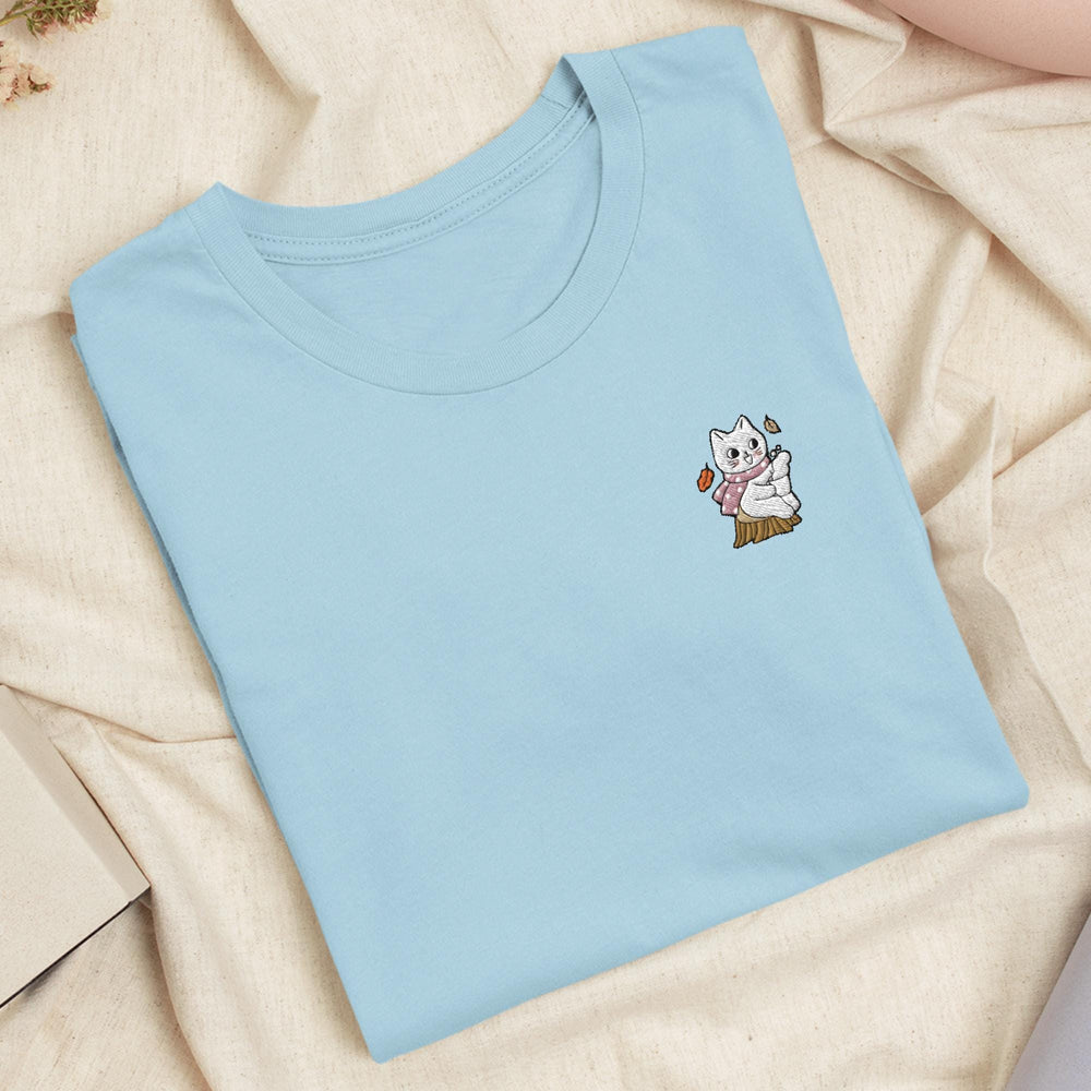 a blue t - shirt with a picture of a cat on it