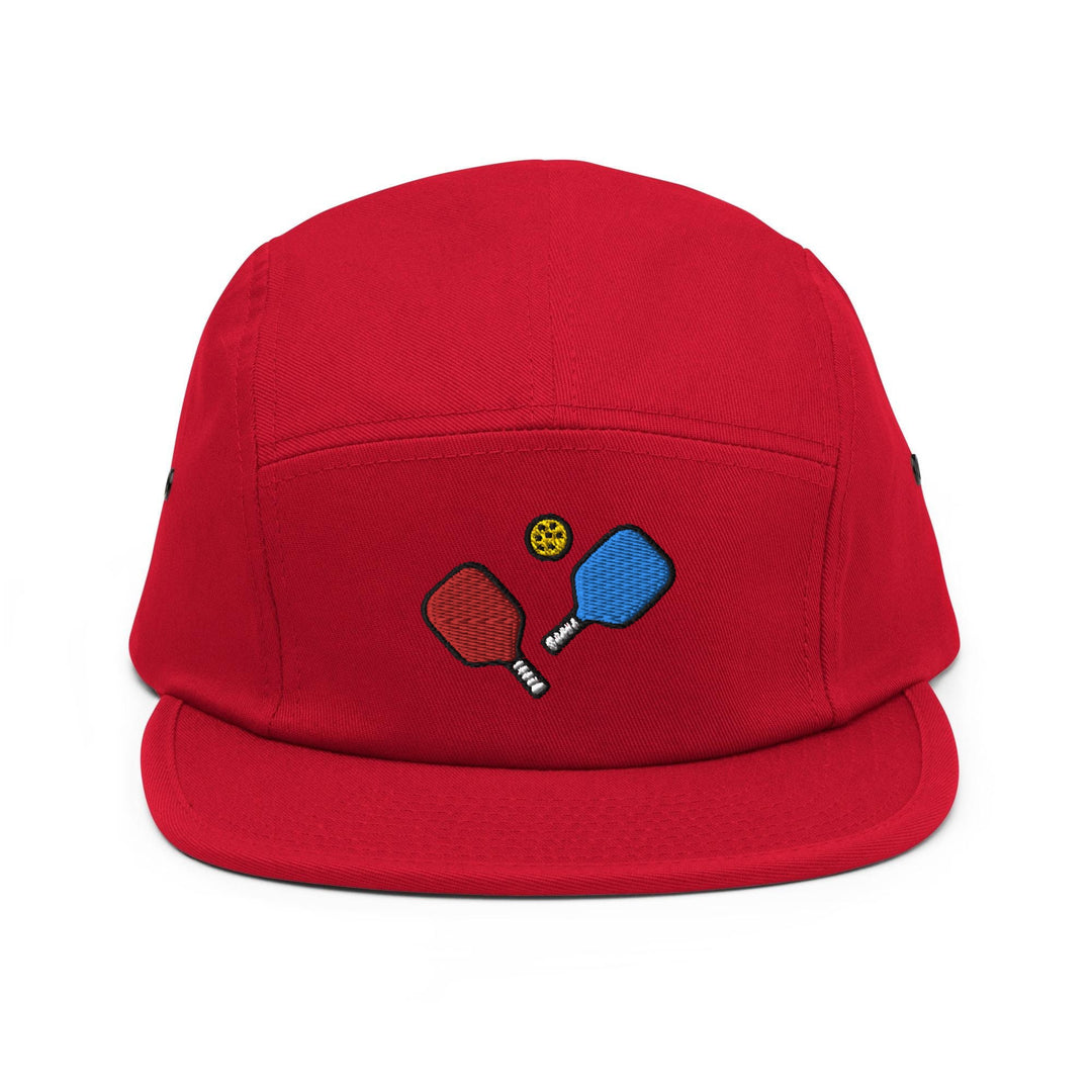 a red hat with two ping pong paddles on it