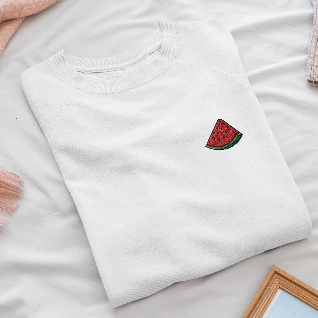 a white t - shirt with a watermelon embroidered on it