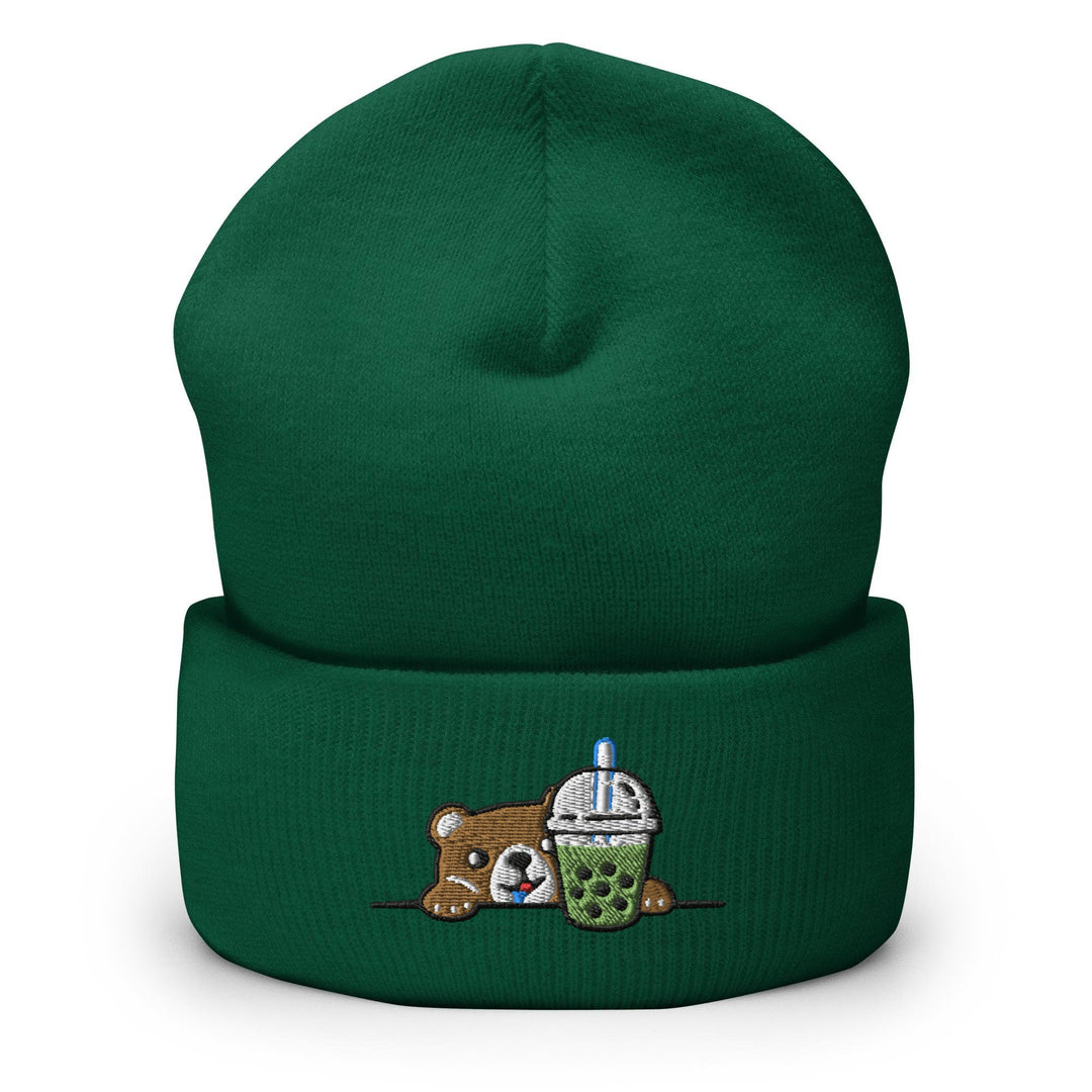 a green beanie with a teddy bear holding a cup