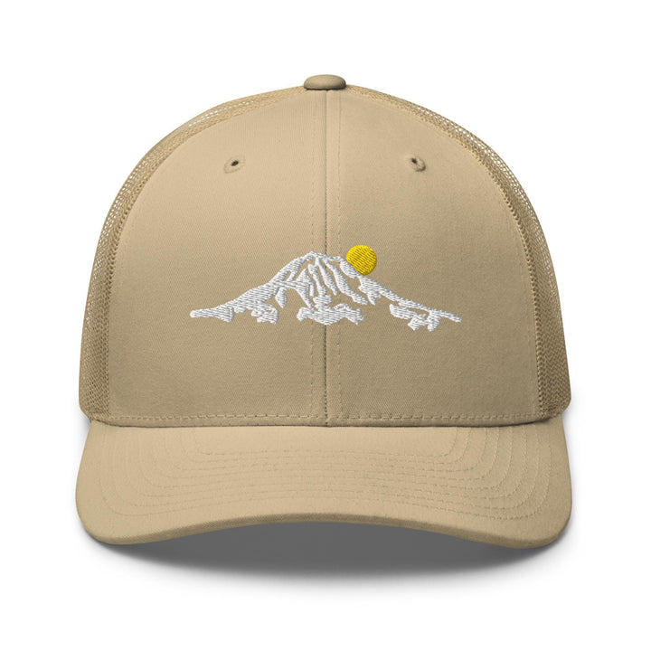 a tan trucker hat with a picture of a mountain