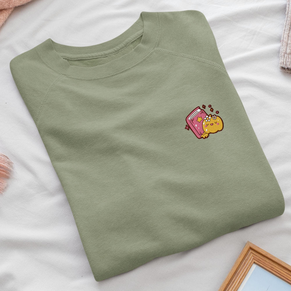 a green t - shirt with a cartoon character on it