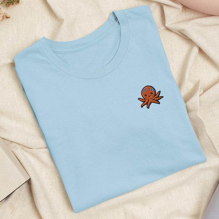 a blue t - shirt with a picture of an octopus on it
