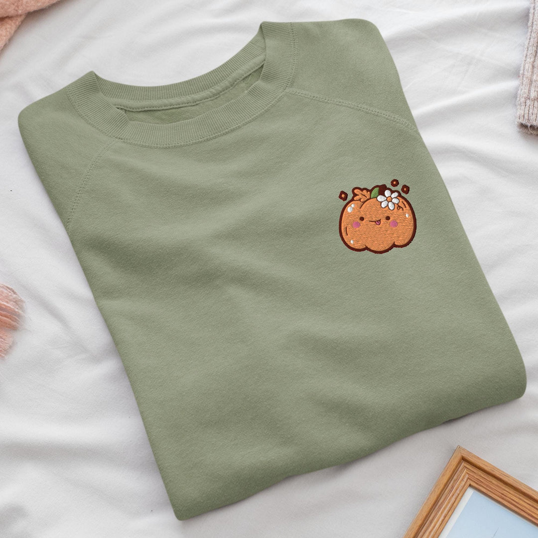 a green t - shirt with a picture of a pumpkin on it