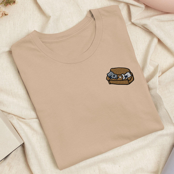 a t - shirt with a picture of two cats in a box on it
