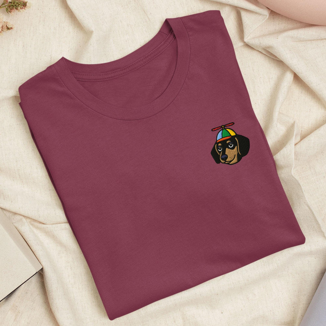a red t - shirt with a dog embroidered on it