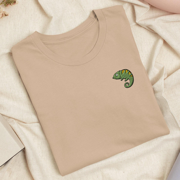 a t - shirt with a green chamelon embroidered on it
