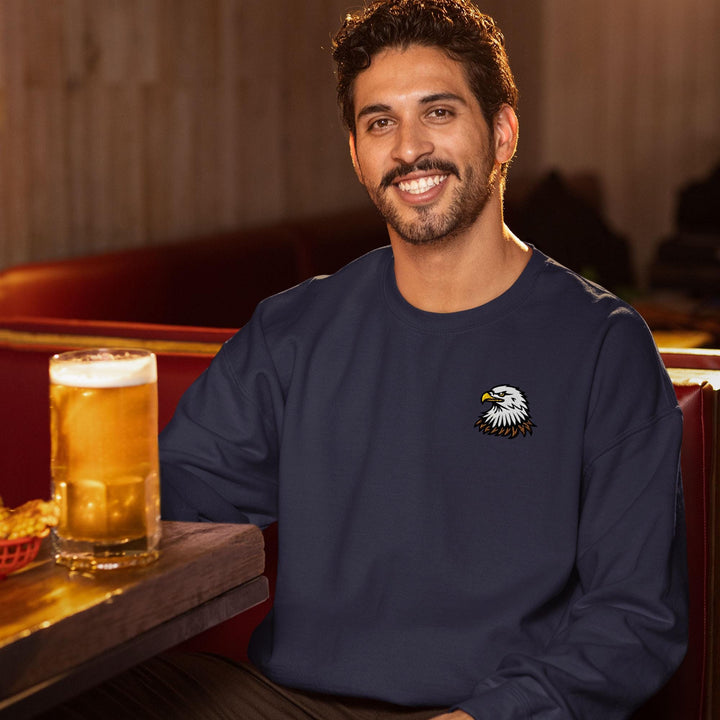 a man sitting at a table with a glass of beer