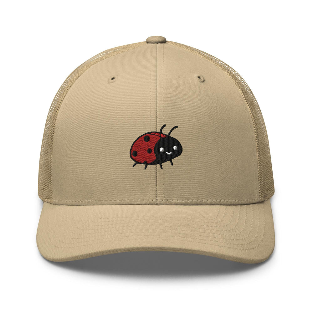 a tan hat with a ladybug embroidered on it