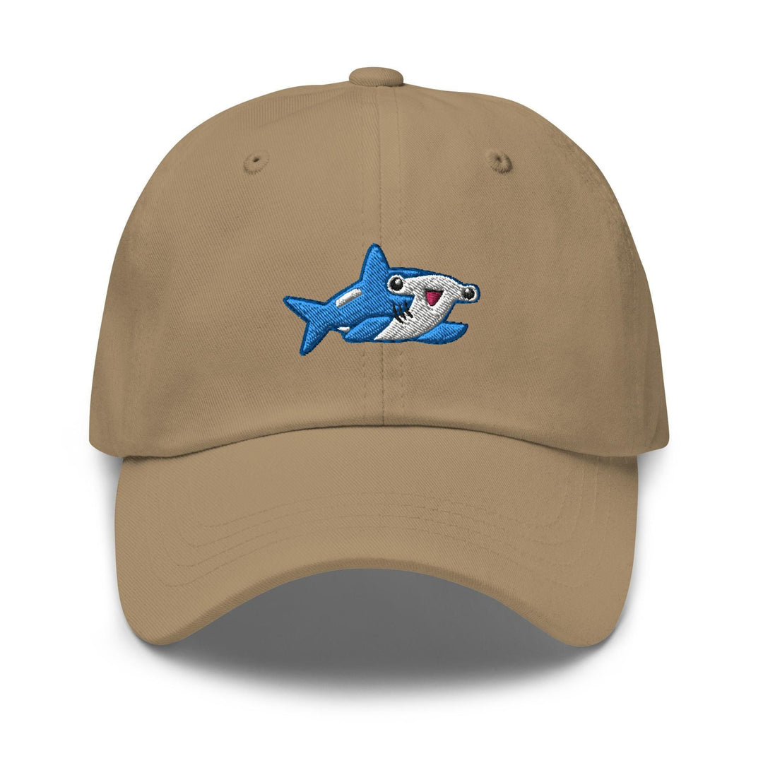 a tan hat with a shark embroidered on it