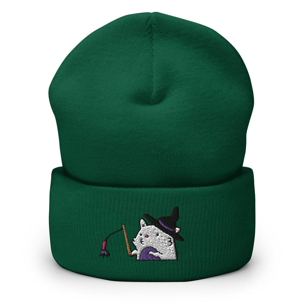 a green beanie with a white cat wearing a witches hat