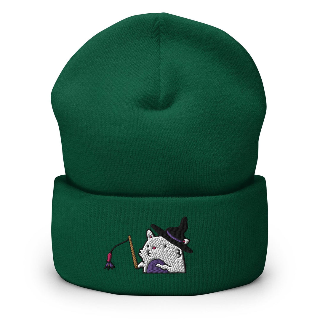 a green beanie with a white cat wearing a witches hat