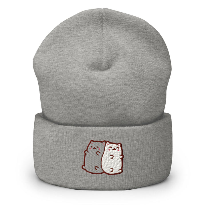 a grey beanie with two cats on it