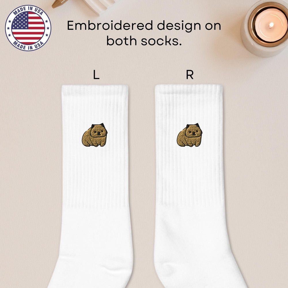 a pair of white socks with a brown dog on it