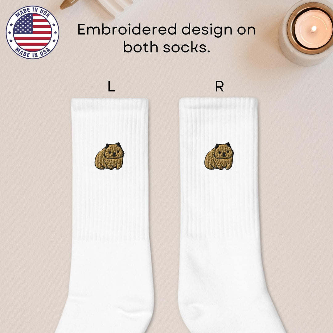 a pair of white socks with a brown dog on it