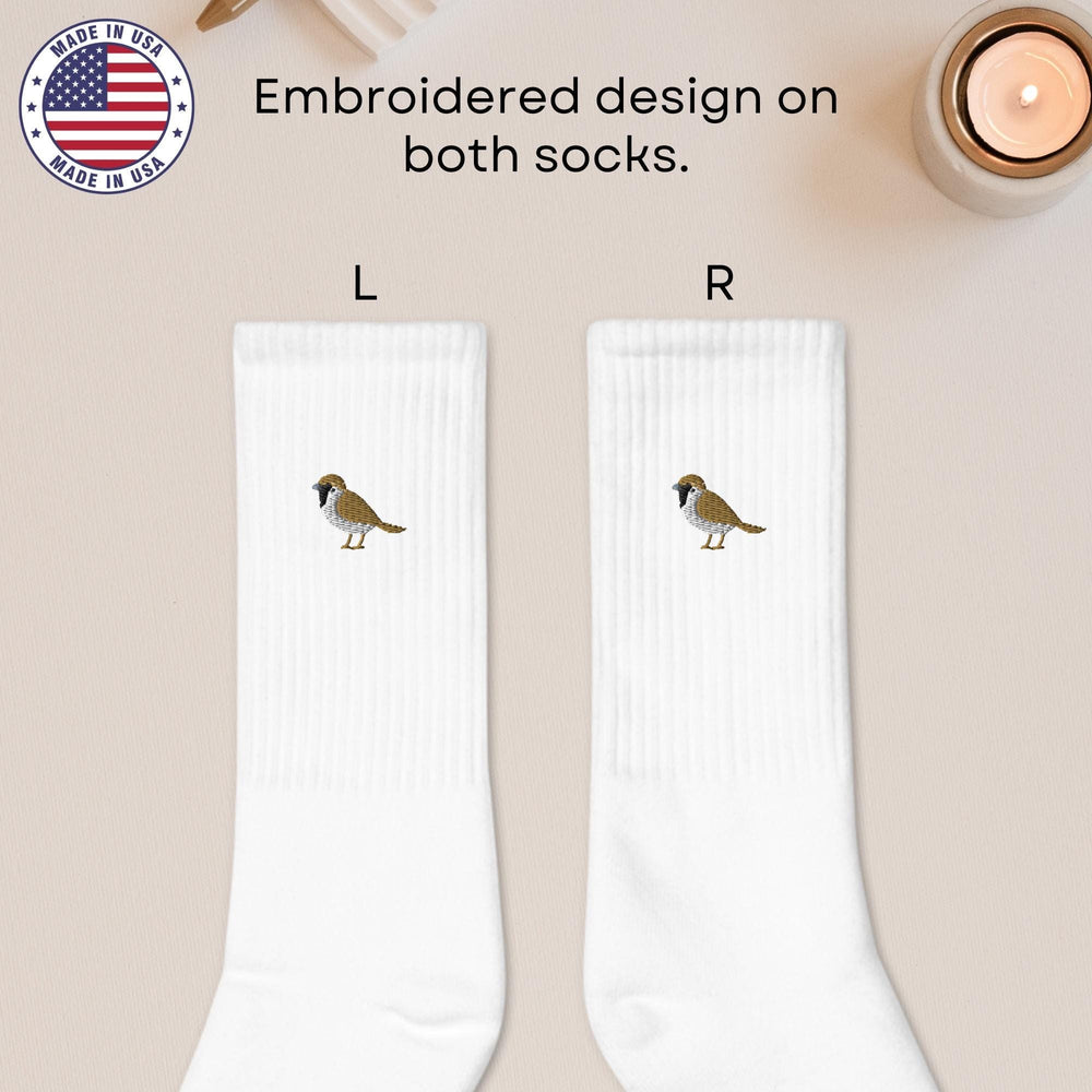 a pair of white socks with a bird on them