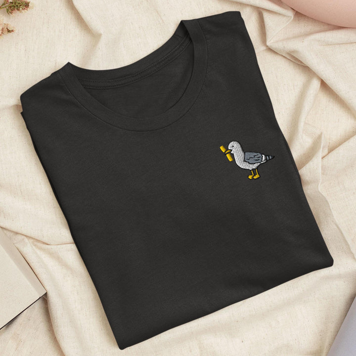 a black t - shirt with a bird embroidered on it