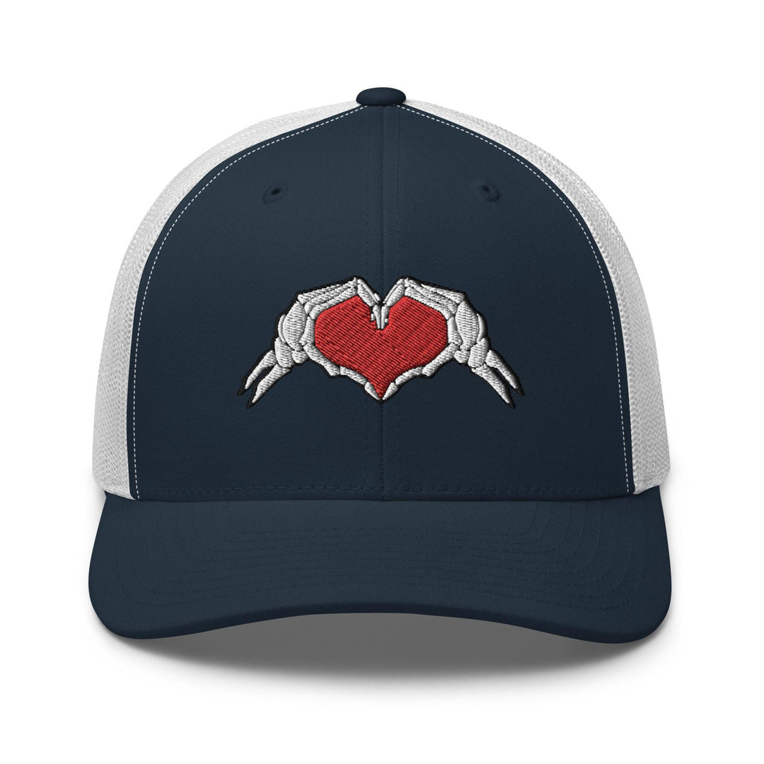a trucker hat with two hands holding a heart