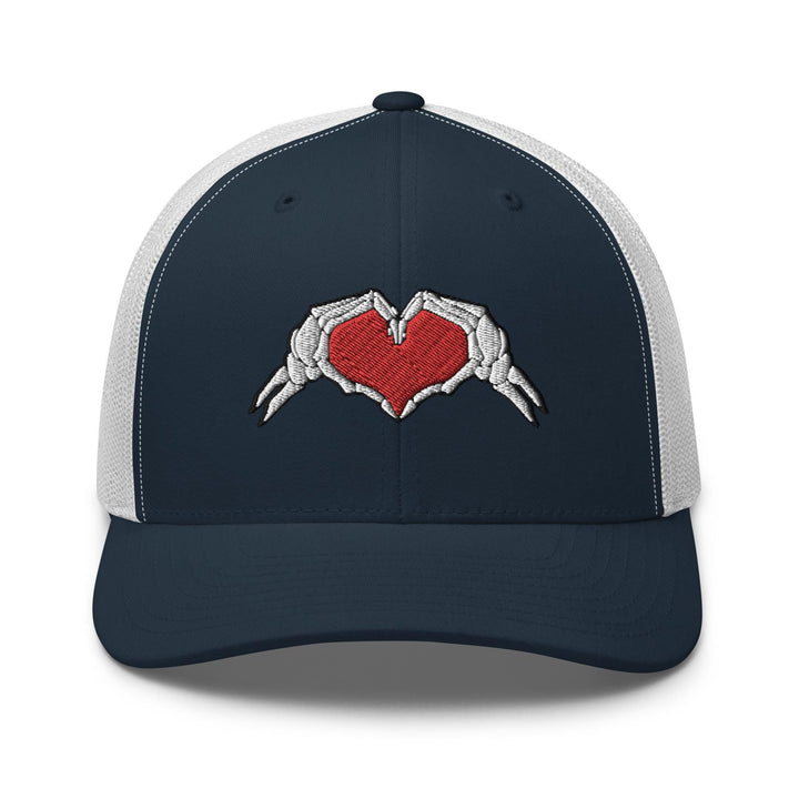 a trucker hat with two hands holding a heart